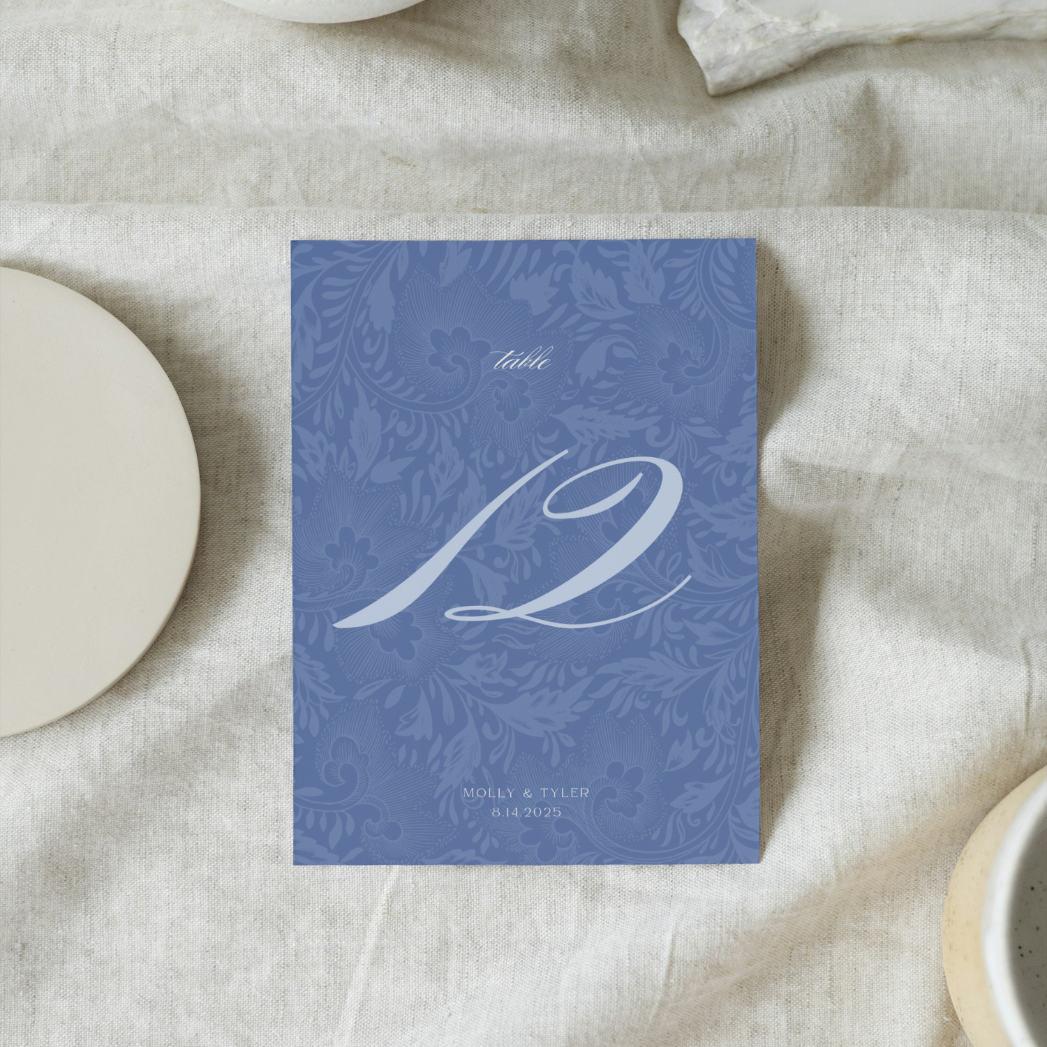 Vintage Blue Wedding Table Stationery Pack showing a table number. It's in a soft classic coastal blue style with a floral pattern.