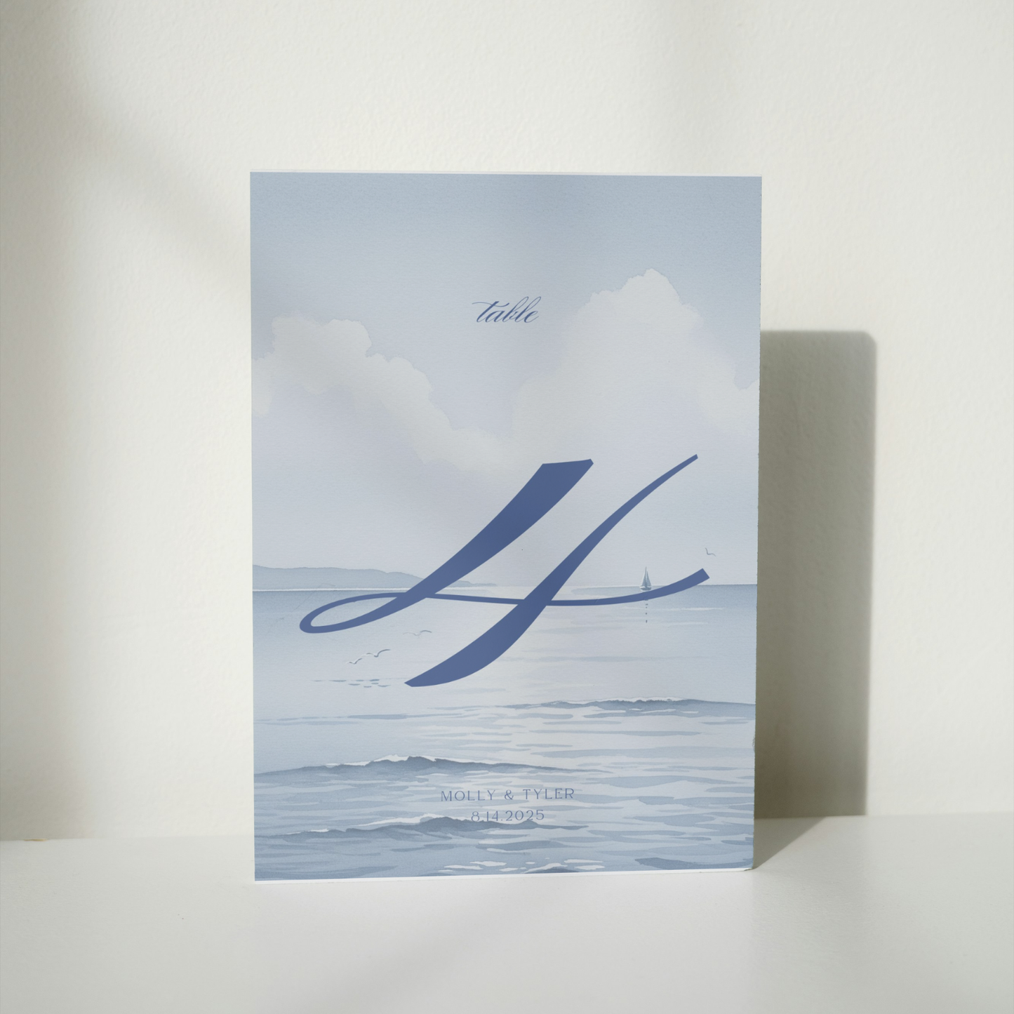 Vintage Blue Wedding Table Stationery Pack showing a part of the table. It's in a soft classic coastal blue style with a watercolor motifs.