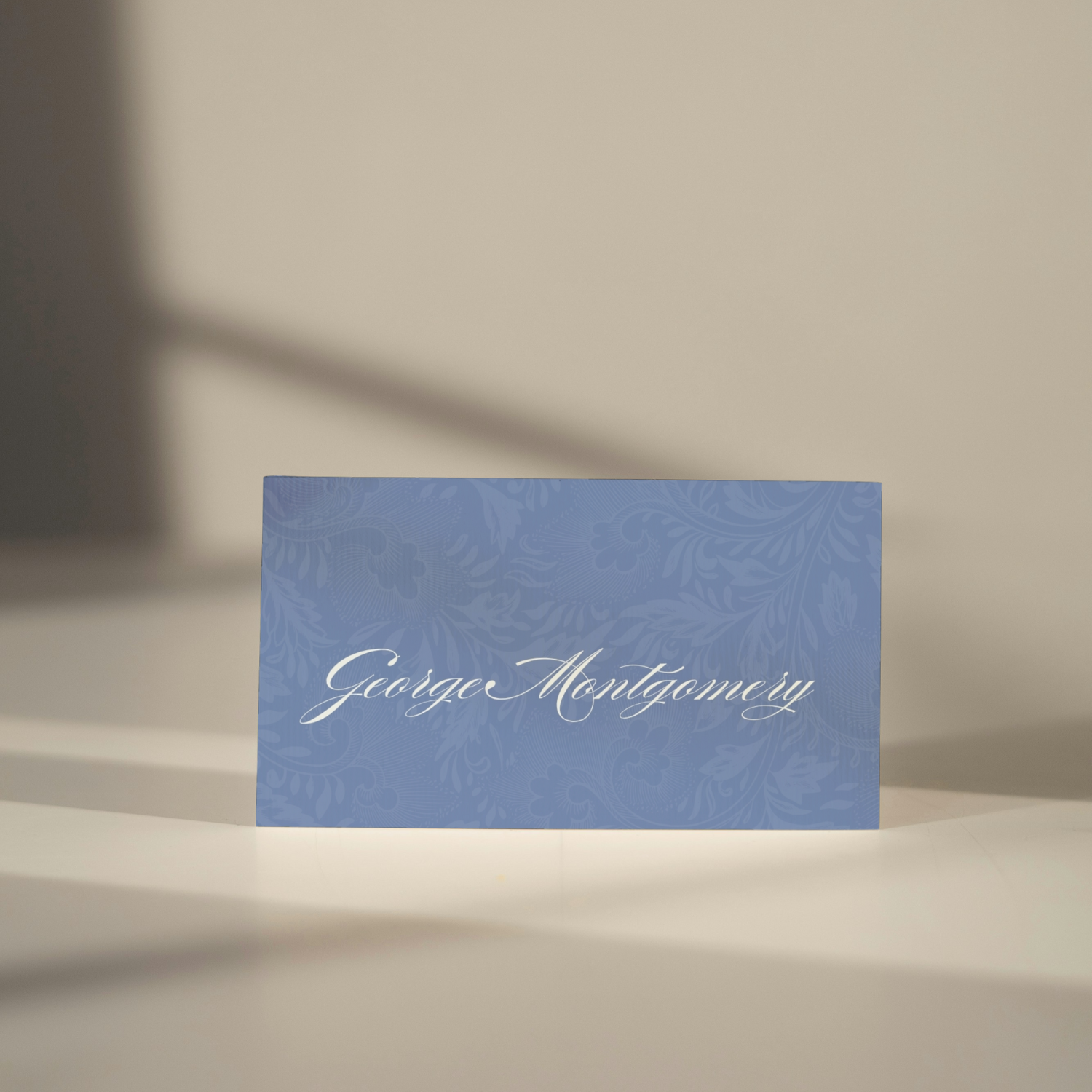 Vintage Blue Wedding Table Stationery Pack showing a place card template. It's in a soft classic coastal blue style with a floral pattern.